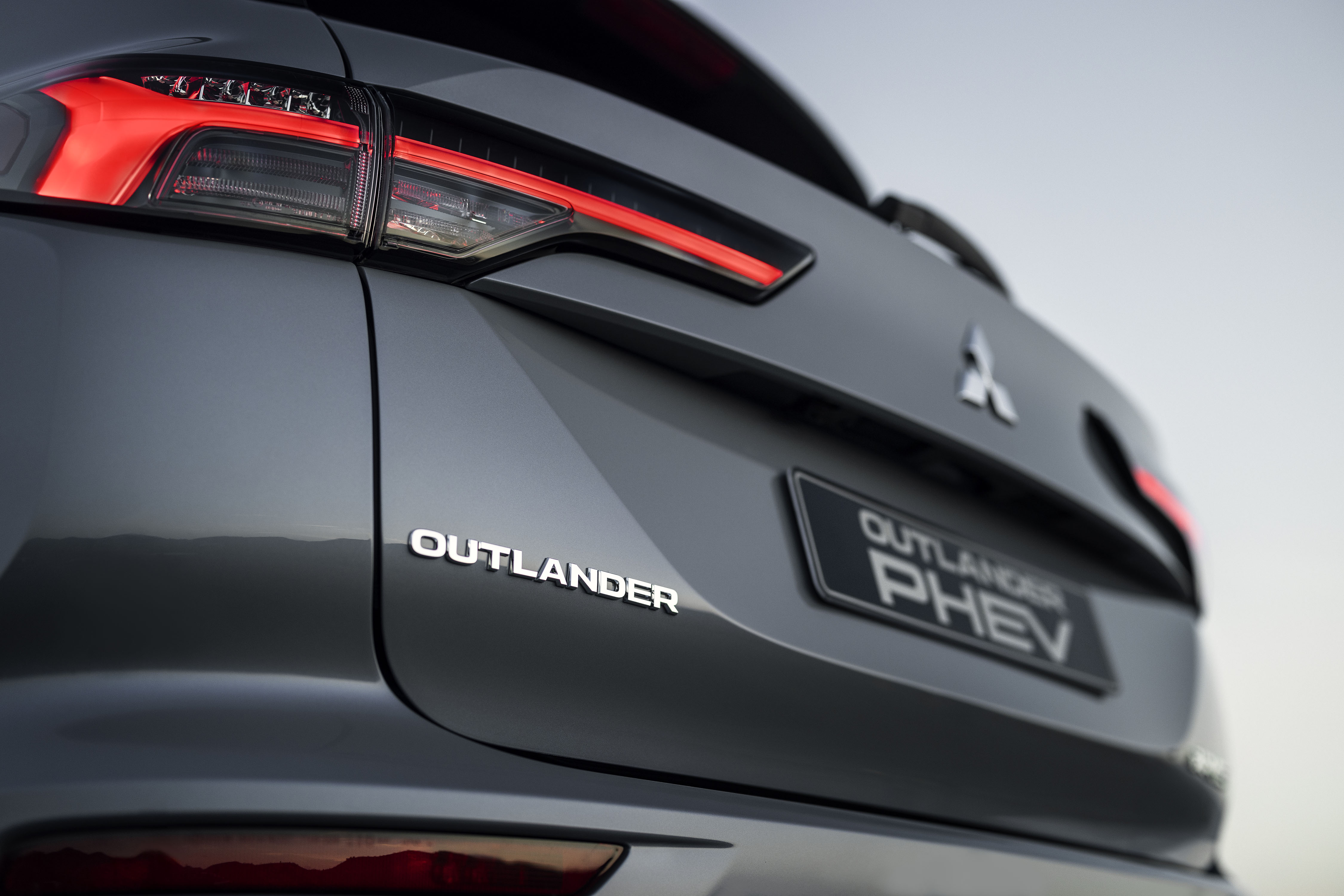 Mitsubishi Outlander PHEV MY2025 in woestijn met wolkenlucht